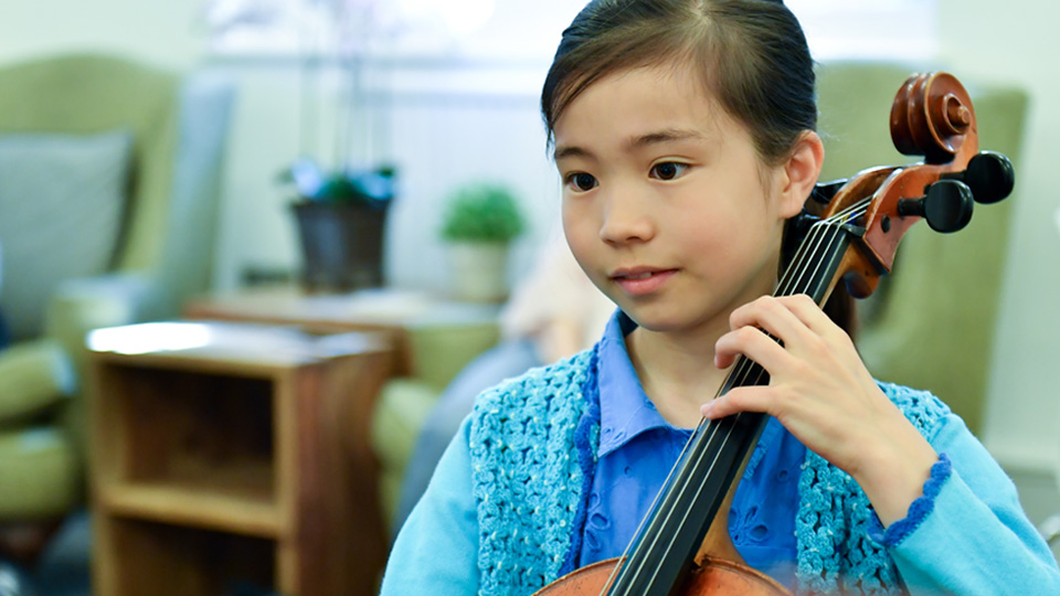 Young student playing the cello